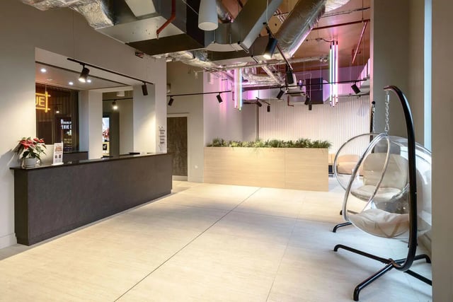 Reception desk plant bubble chairs communal area at True Nottingham in Nottingham Student Accommodation