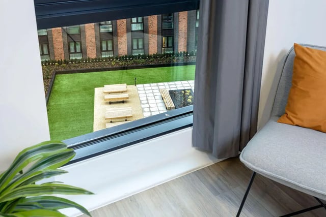 Wooden benches and seating area exterior at True Nottingham in Nottingham Student Accommodation