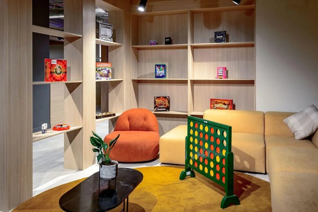 Sofa armchair connect four shelves games living room at True Nottingham in Nottingham Student Accommodation