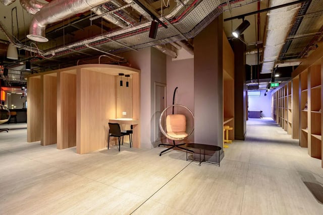 Wooden study booths hanging chair small table common area at True Nottingham in Nottingham Student Accommodation
