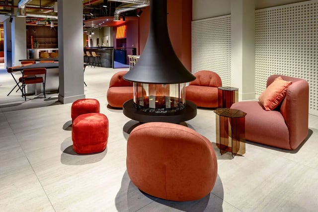 Orange seating fireplace and tables communal area at True Nottingham in Nottingham Student Accommodation