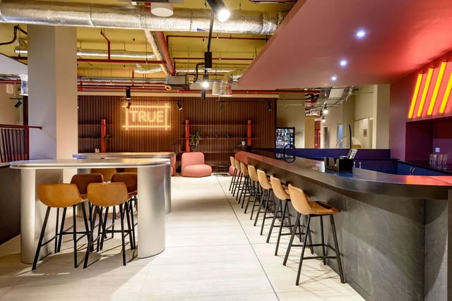 Bar area with tables and chairs lounge at True Nottingham in Nottingham Student Accommodation