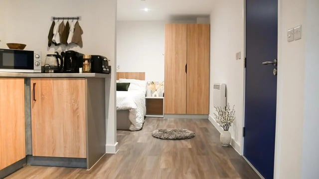 Bed kitchen wardrobe and door studio apartment at Hill View Place in Exeter Student Accommodation