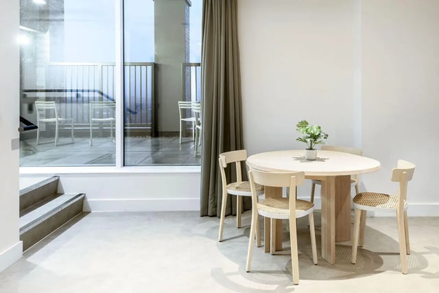 Dining table chairs plant and balcony view dining area at True Sheffield in Sheffield Student Accommodation