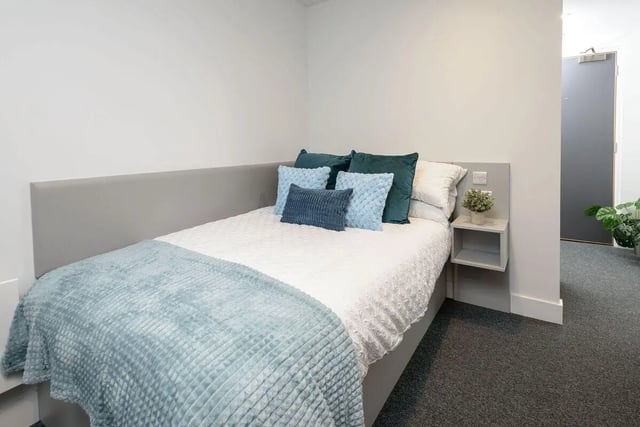 Bed with pillows and blue throw blanket bedroom at True Sheffield in Sheffield Student Accommodation