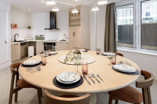 Dining table set with placemats plates cutlery and glasses dining area at True Sheffield in Sheffield Student Accommodation