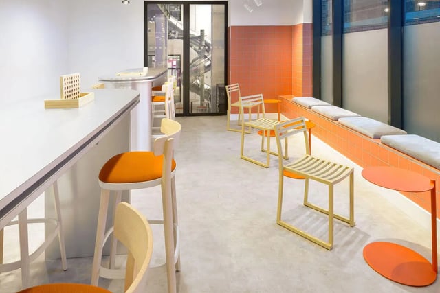 Orange bar stools connect four game common area at True Sheffield in Sheffield Student Accommodation