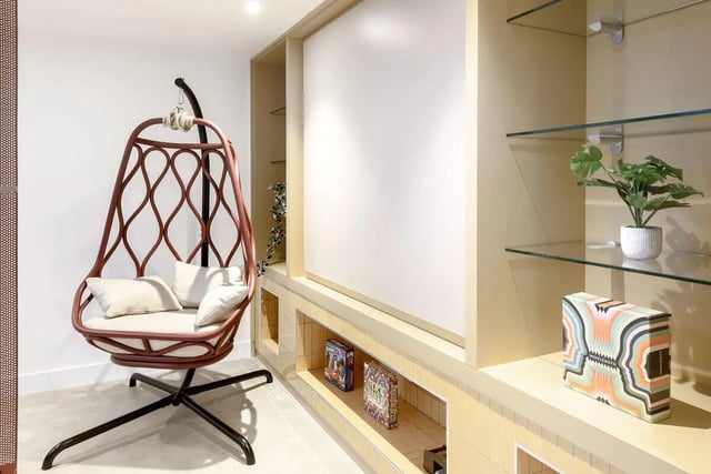 Hanging chair shelves with books and plant Living room at True Sheffield in Sheffield Student Accommodation