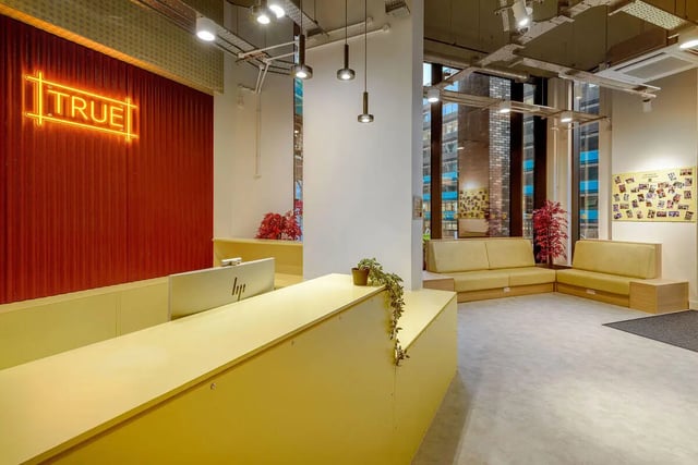 Reception desk sofas and neon sign lobby at True Sheffield in Sheffield Student Accommodation