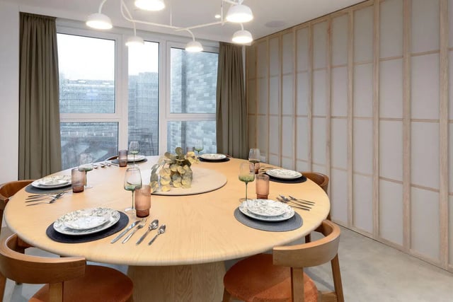 Round dining table set with plates and glasses dining area at True Sheffield in Sheffield Student Accommodation