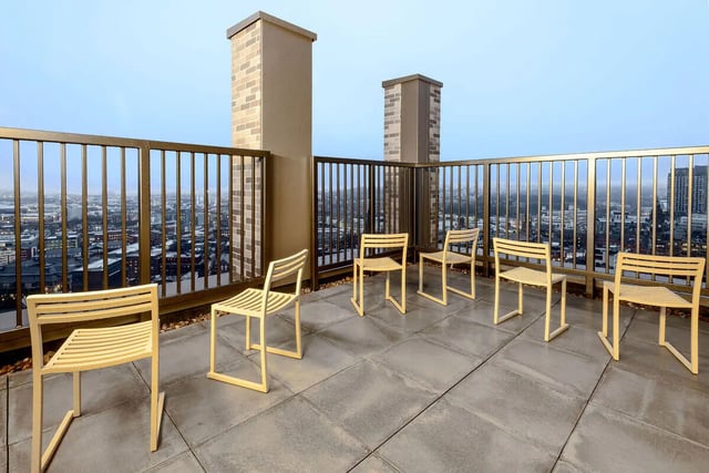 Chairs on a rooftop balcony with city view exterior at True Sheffield in Sheffield Student Accommodation