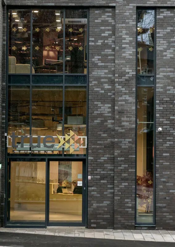 Modern brick building with large windows exterior at True Sheffield in Sheffield Student Accommodation