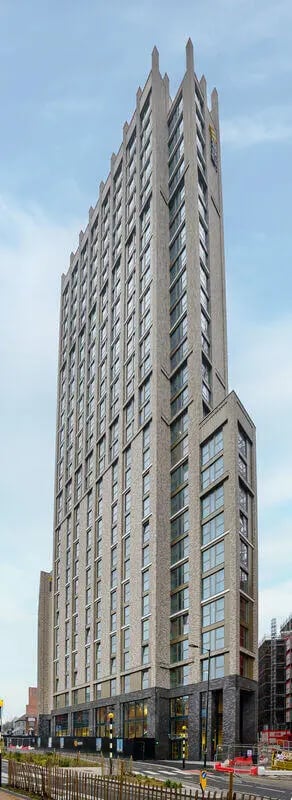 Modern high rise brick building with many windows exterior at True Sheffield in Sheffield Student Accommodation