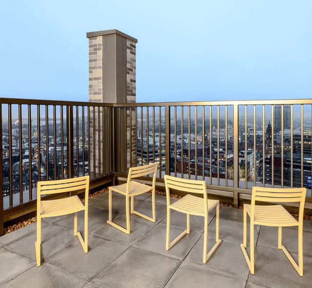 Four yellow chairs on rooftop patio exterior at True Sheffield in Sheffield Student Accommodation