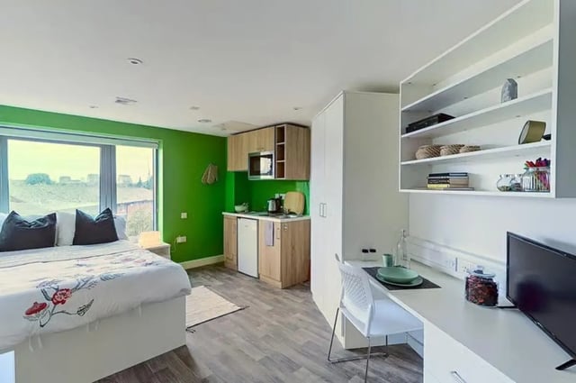 Bed kitchen desk and shelves student studio at The Cube Greenwich in London Student Accommodation