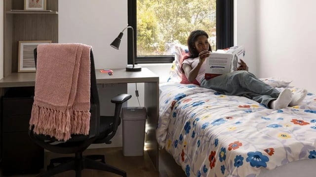 Desk bed lamp trash can and student bedroom at UniLodge Perth Central in Perth Student Accommodation
