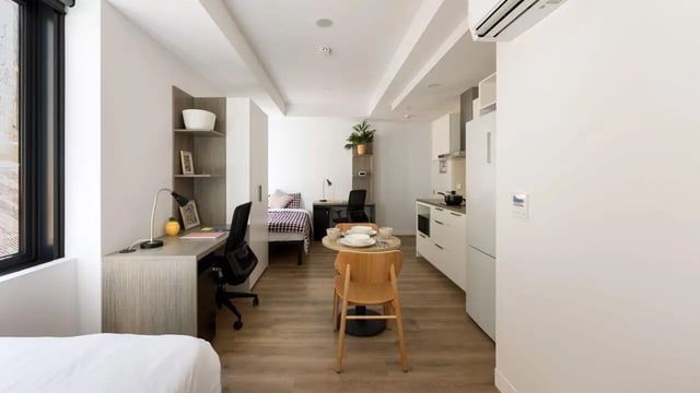 Bed desk table chairs kitchen and bedroom Studio at UniLodge Perth Central in Perth Student Accommodation