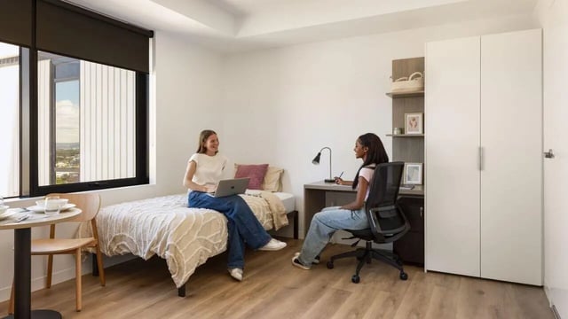 Two students study at desk and bed bedroom at UniLodge Perth Central in Perth Student Accommodation