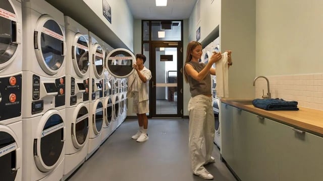 Students near dryers and sink laundry room at UniLodge Perth Central in Perth Student Accommodation