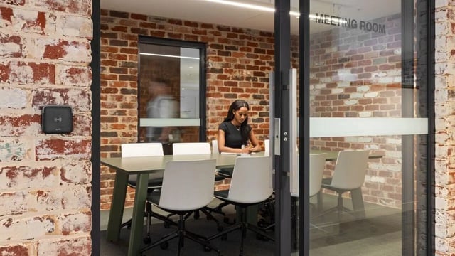 Meeting room with woman at table and chairs meeting room at UniLodge Perth Central in Perth Student Accommodation