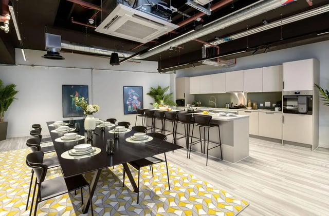 Large dining table with chairs kitchen island kitchen living area at True Leicester in Leicester Student Accommodation