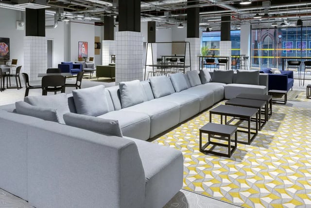 Modern common room with grey sofas and tables Living room at True Leicester in Leicester Student Accommodation