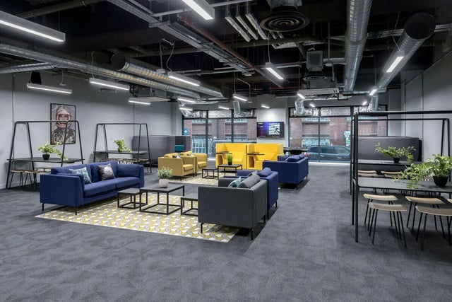 Modern communal lounge with blue sofas yellow chairs living room at True Leicester in Leicester Student Accommodation
