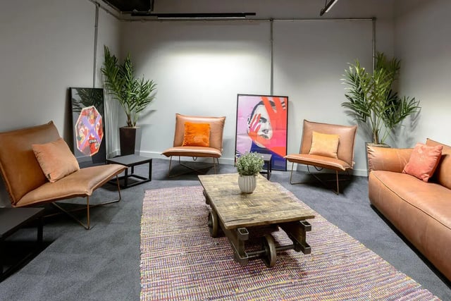 Brown chairs table artwork plants living room at True Leicester in Leicester Student Accommodation