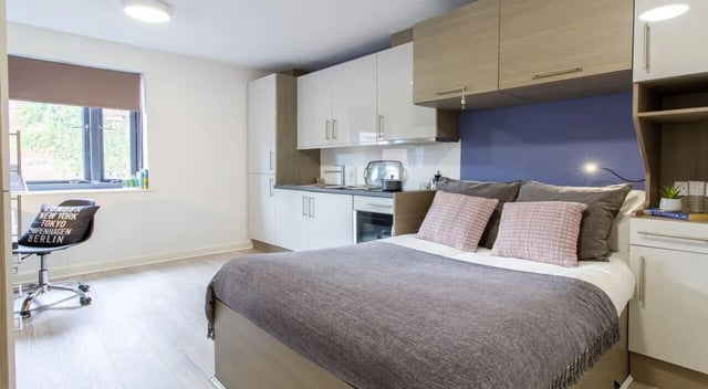 Bed kitchen and desk area student studio at St Giles Studios in Durham Student Accommodation