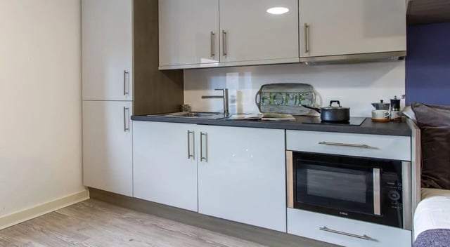 Modern kitchen with microwave sink and cabinets kitchen at St Giles Studios in Durham Student Accommodation