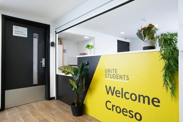Welcome desk with plants and staff only door reception area at The Bakery in Cardiff Student Accommodation