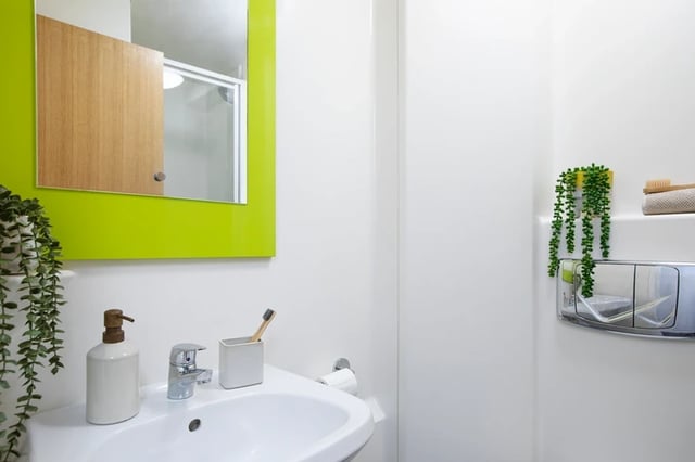 Sink soap dispenser toothbrush holder toilet cistern bathroom at The Bakery in Cardiff Student Accommodation