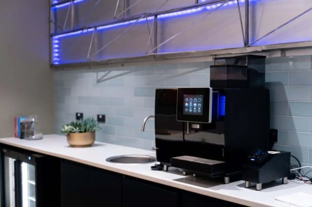 Coffee machine sink plant and mini fridge kitchen area at LIV Student Belfast in Belfast Student Accommodation