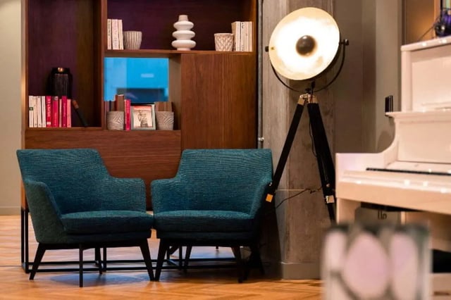 Two blue armchairs and bookshelf Common Area at LIV Student Belfast in Belfast Student Accommodation