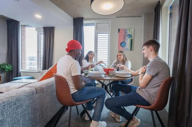 Students eating at dining table living room at LIV Student Sheffield in Sheffield Student Accommodation