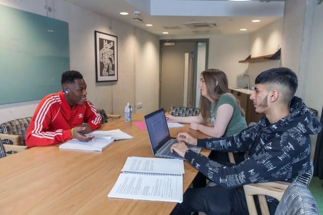 Students study at large table with laptop study area at LIV Student Sheffield in Sheffield Student Accommodation