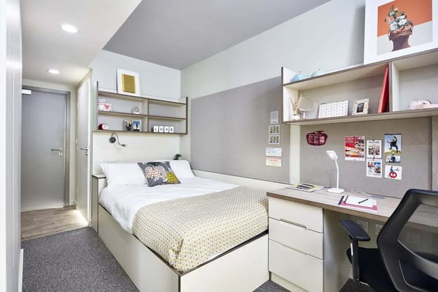 Bed desk shelves with notices and art Bedroom at LIV Student Sheffield in Sheffield Student Accommodation