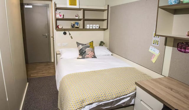 Bed with patterned throw and pillow Bedroom at LIV Student Sheffield in Sheffield Student Accommodation