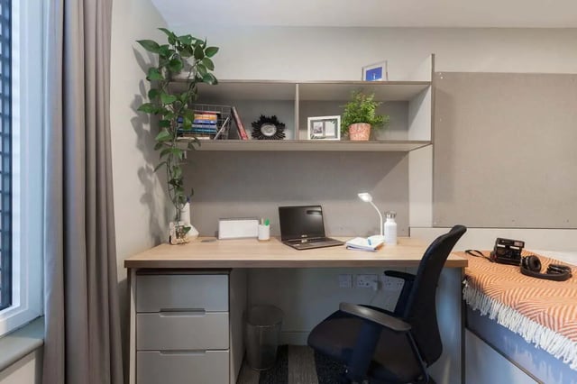 Desk with laptop plant and chair study area at LIV Student Sheffield in Sheffield Student Accommodation