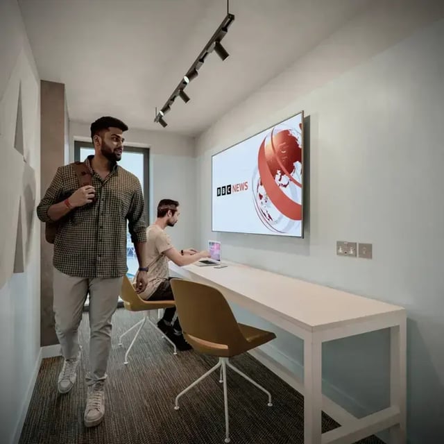 Two men and long desk with TV Study area at Hawthorne House in London Student Accommodation