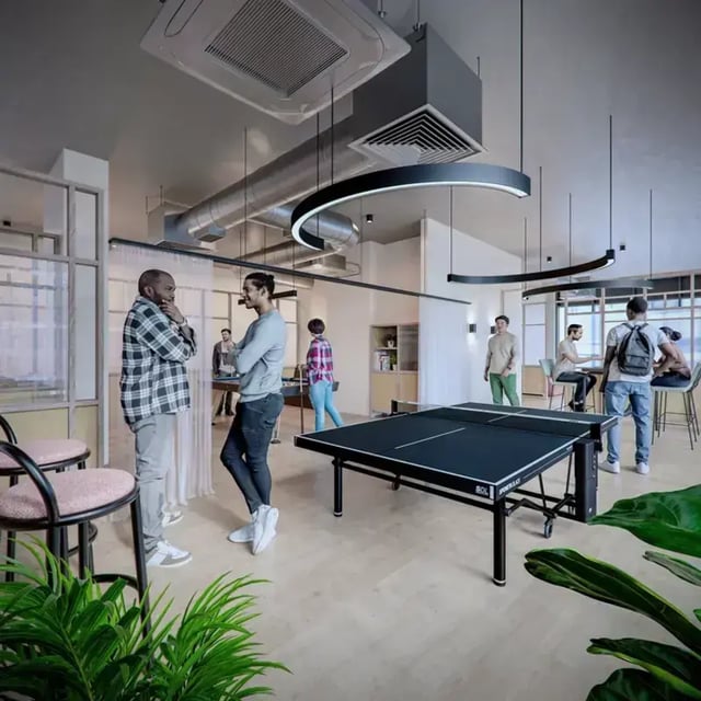 Ping pong table and lounge area students interacting common room at Hawthorne House in London Student Accommodation