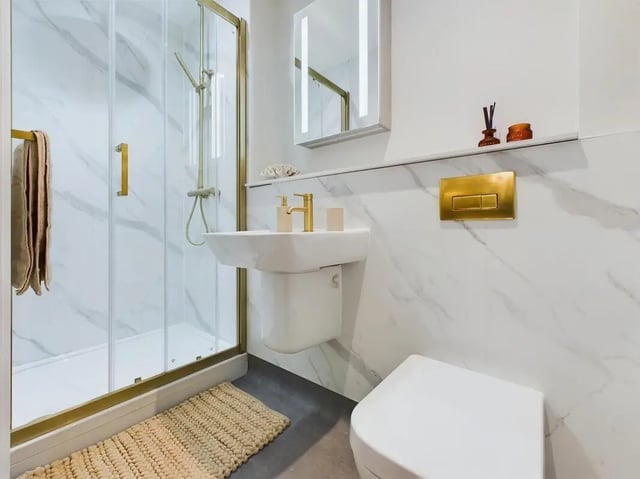 Modern bathroom with shower sink toilet and mirror bathroom at 26 Great George Street in Leeds Student Accommodation