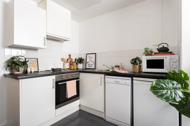 White cabinets oven dishwasher microwave kitchen at Shrubhill House in Edinburgh Student Accommodation