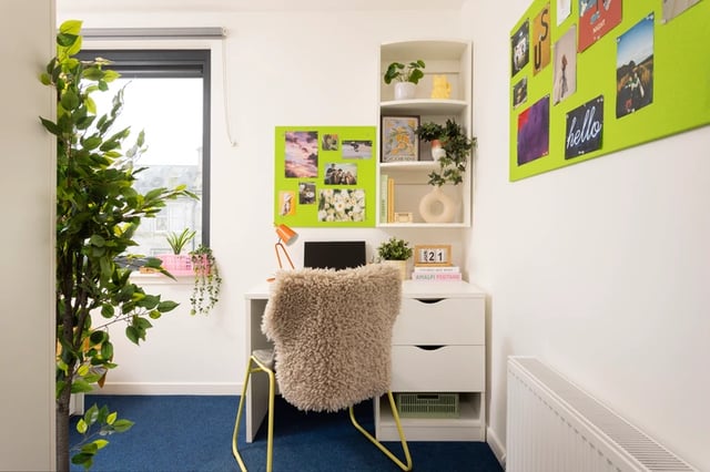 Desk with chair laptop and plants study area at Shrubhill House in Edinburgh Student Accommodation