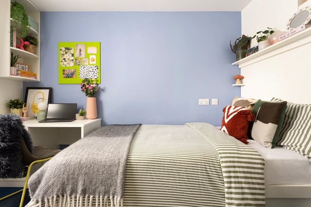 Bed desk laptop flowers and shelves bedroom at Shrubhill House in Edinburgh Student Accommodation