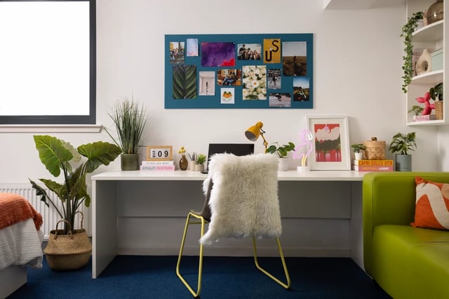 Desk with lamp calendar and framed art study area at Shrubhill House in Edinburgh Student Accommodation