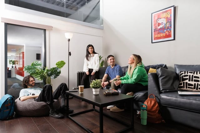 Students on couch beanbag with coffee table living room at Shrubhill House in Edinburgh Student Accommodation