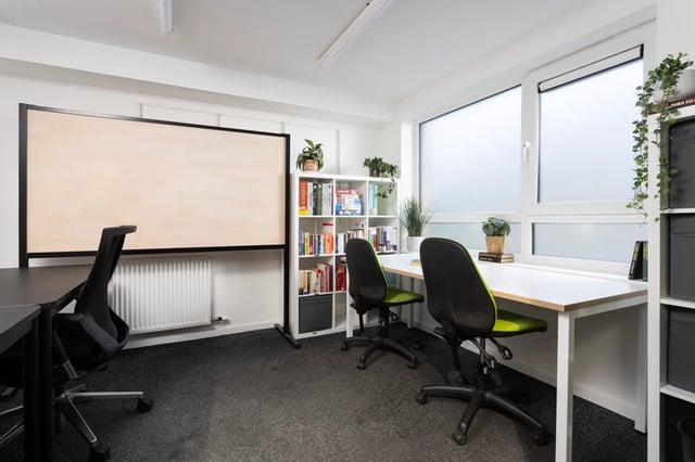 Desk chairs bookshelf and large whiteboard study area at Murano House in Edinburgh Student Accommodation
