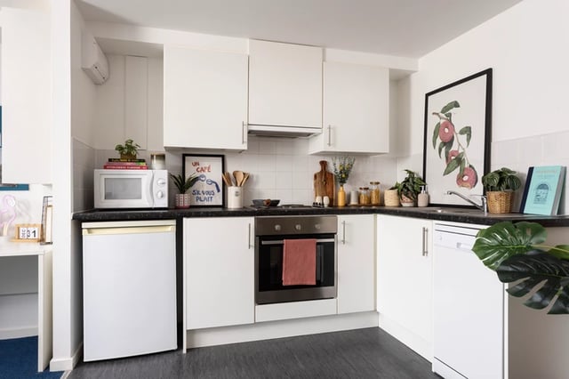 White cabinets microwave oven and dishwasher kitchen at Murano House in Edinburgh Student Accommodation