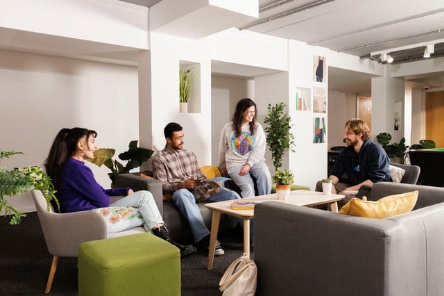 Four students sitting on sofas in lounge living room at Murano House in Edinburgh Student Accommodation